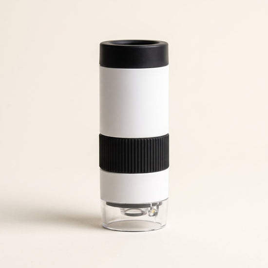 Curio Pocket Microscope on a plain studio background