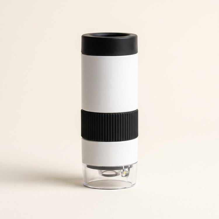 Curio Pocket Microscope on a plain studio background